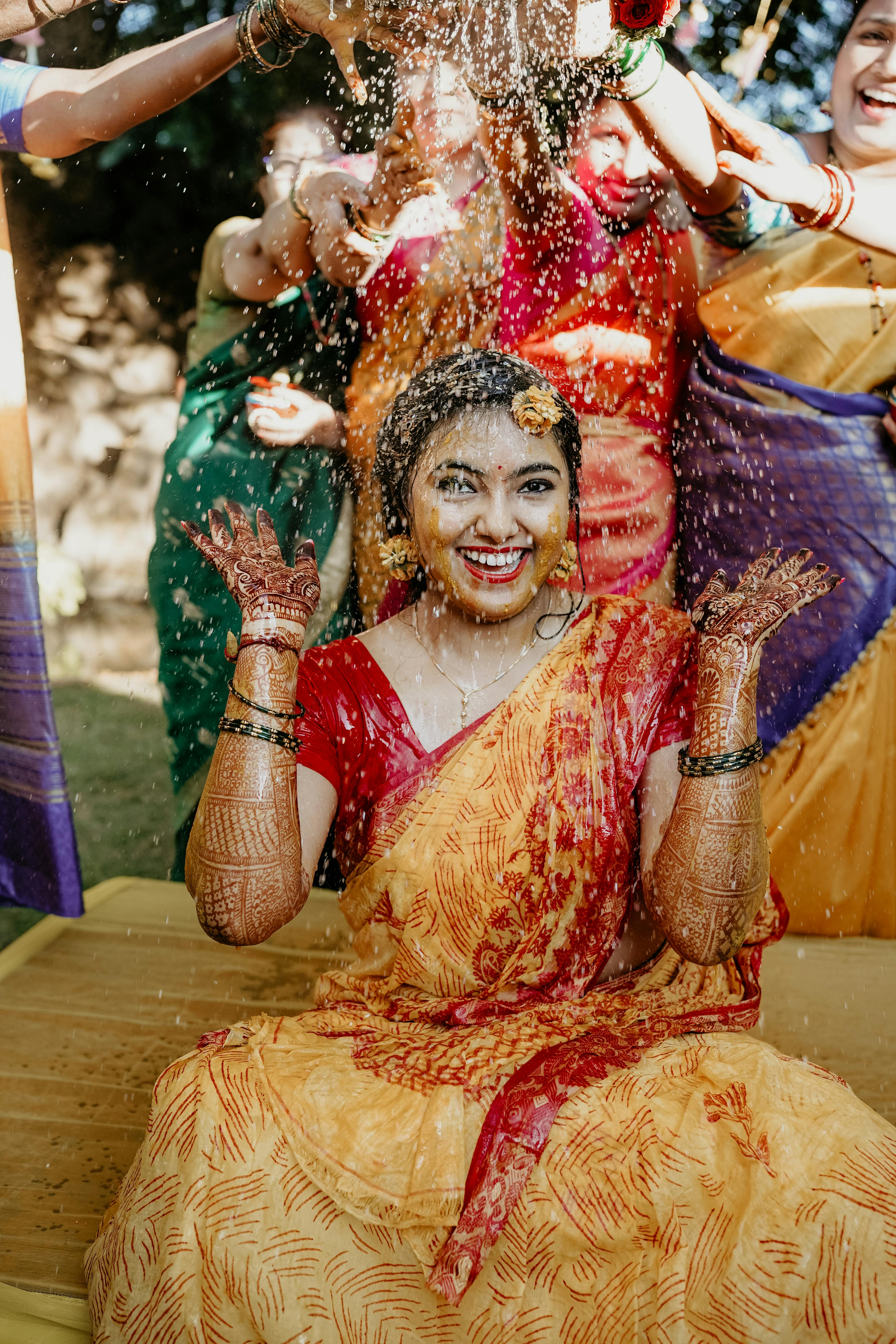 free photo of bride smiling during a traditional indian wedding custom