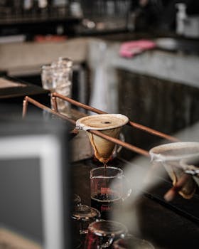 Artisanal coffee brewing technique with cone filters in a cosy café setting.