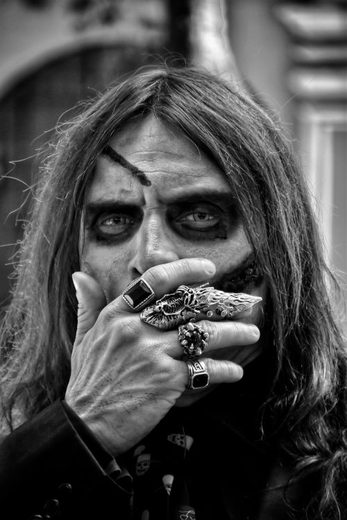 Free Close-up black and white portrait of a man with gothic makeup and jewelry. Stock Photo