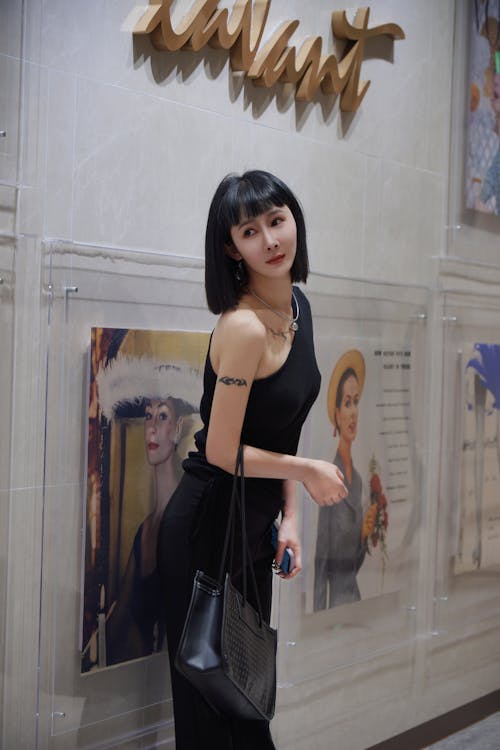 Young Woman Posing in Museum near Paintings