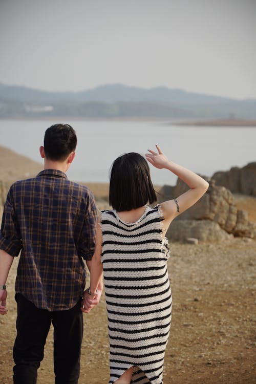 Couple Posing on Rocks near Water