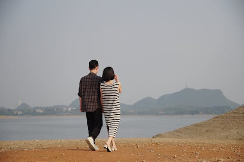 Young Couple Walking Towards the Sea