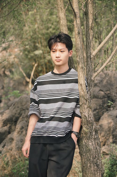 Teenage Boy Leaning Against a Tree