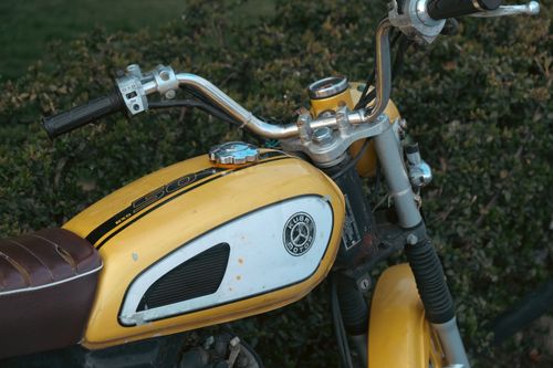Free Close-up of a vintage yellow motorcycle tank, embodying retro vibes. Stock Photo
