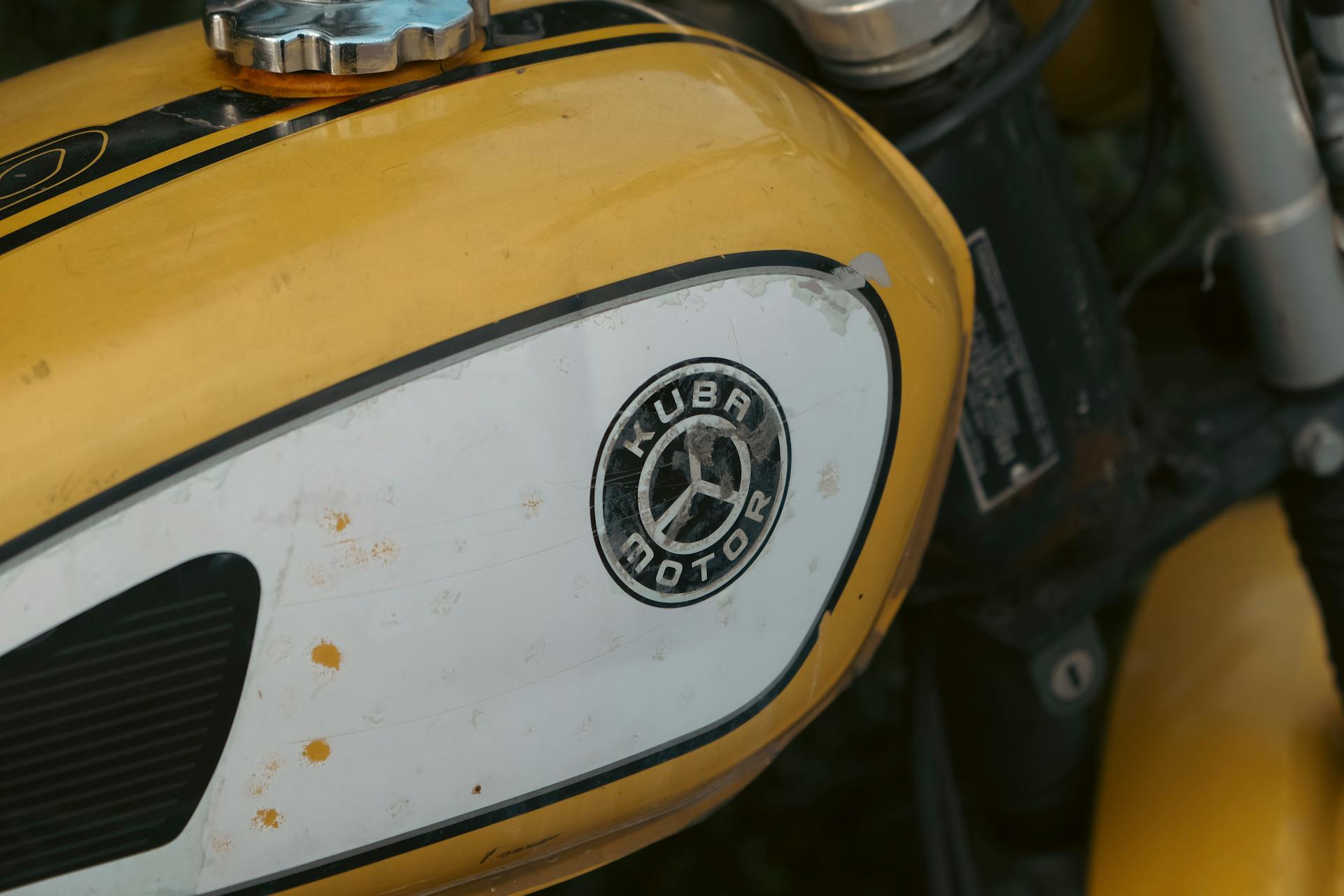 Detailed view of a Kuba motorbike's gas tank highlighting its logo and vintage design.