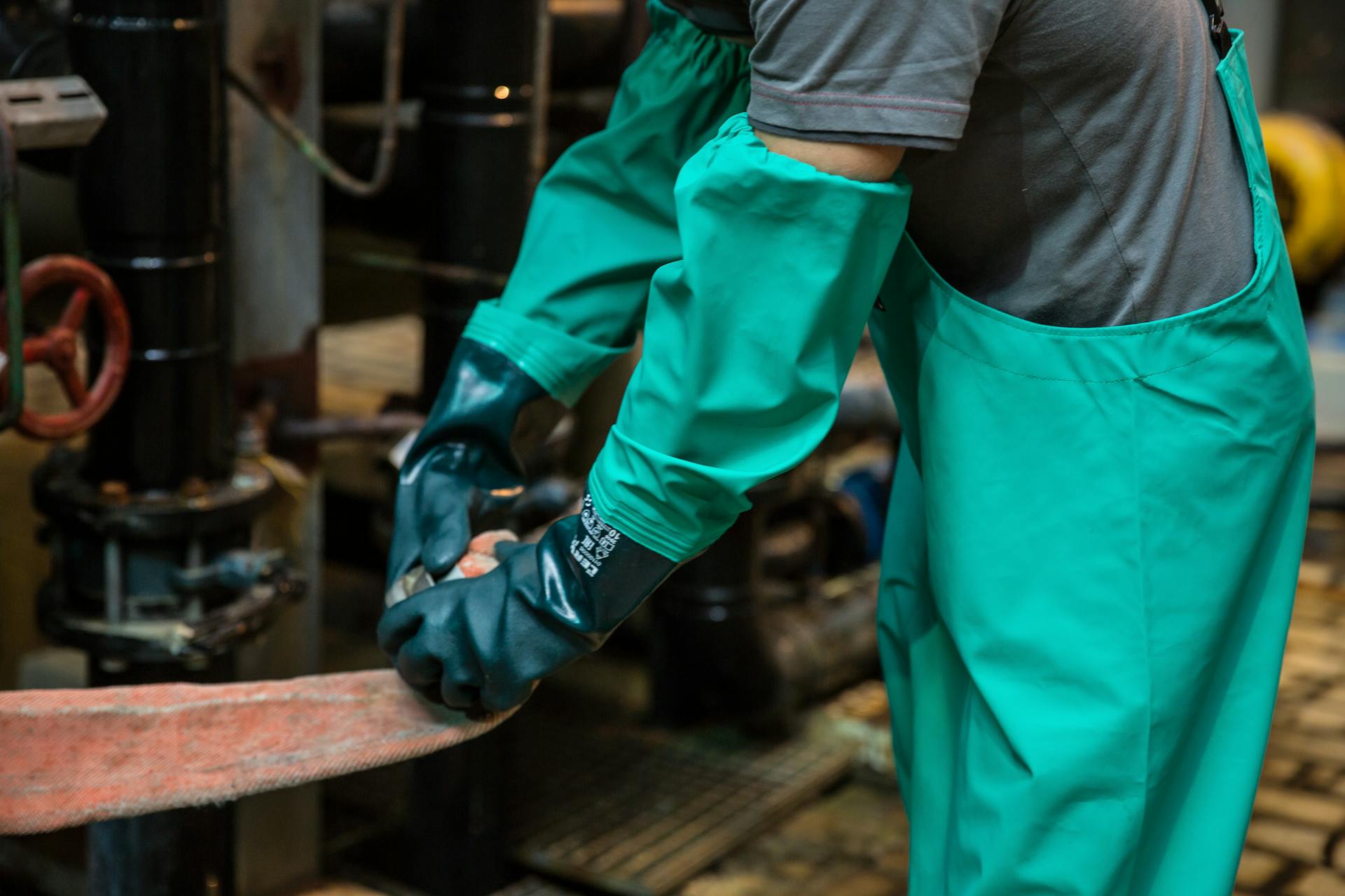 Man Working in Gloves and Protective Clothing