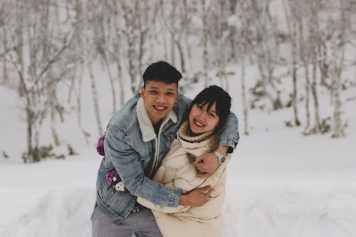 Free Man and Woman Embracing Each Other on Winter Outdoors Stock Photo