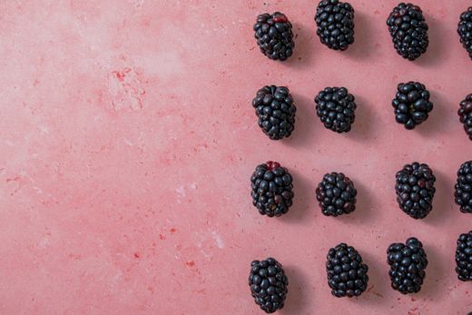 Blackberries arranged on a pink surface — photo by Georgie Devlin on Pexels