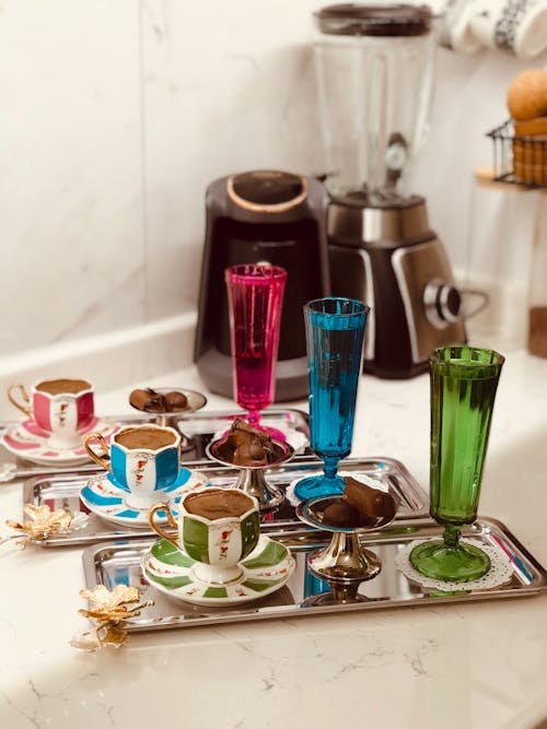 Colroful Glasses and Decorative Cups with Coffee on Trays