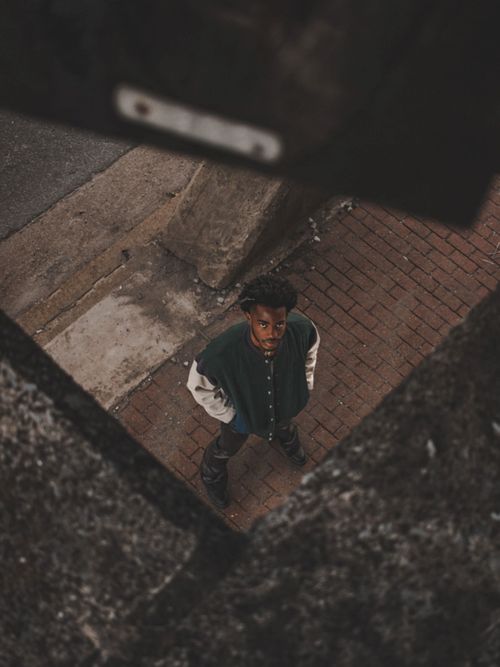 Free A high-angle view of a man standing on a brick pavement in an urban setting, Nashville, TN. Stock Photo