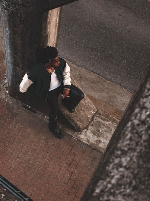 High Angle View of a Man Leaning on a Street Column