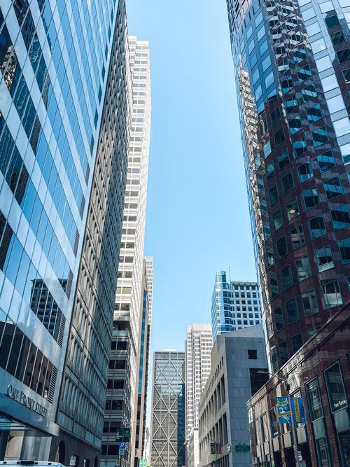Free High rise buildings in a vibrant urban cityscape under clear blue skies. Stock Photo