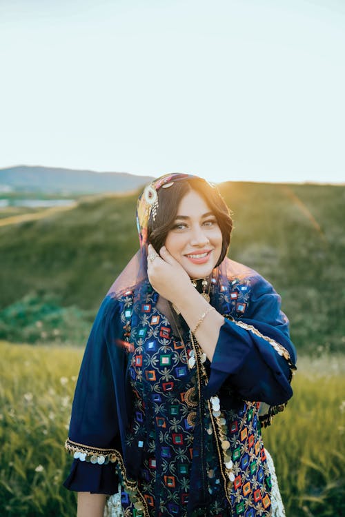 Smiling Woman in Traditional Clothing at Sunset