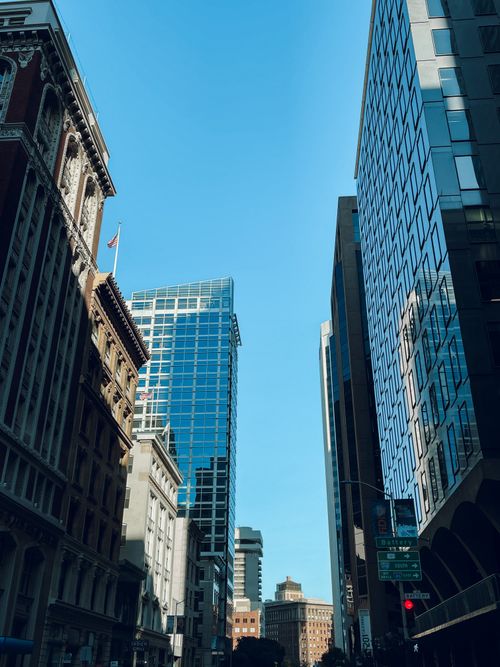 Free A cityscape featuring modern skyscrapers against a clear blue sky, showcasing urban architecture. Stock Photo