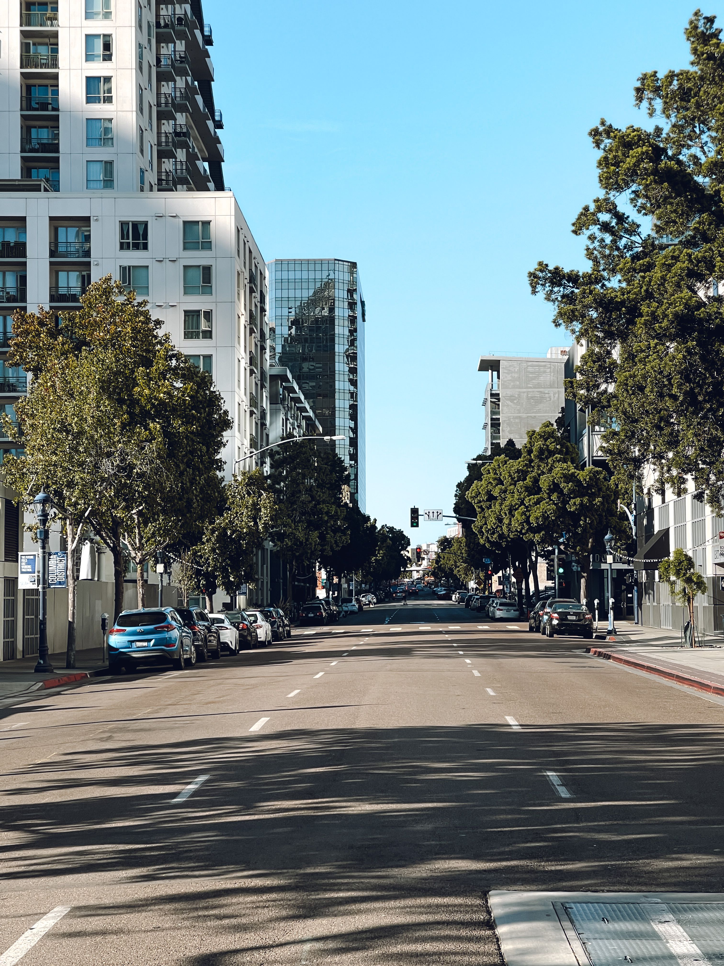 A City Street between Modern Buildings in Summer · Free Stock Photo