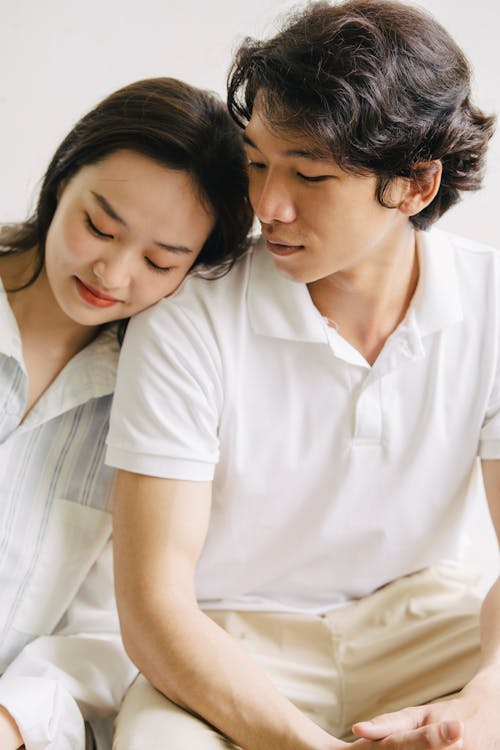 Free Photo of a Young Woman Leaning Her Head on a Young Mans Shoulder Stock Photo