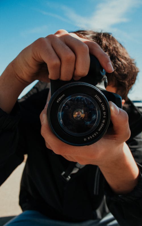 Close-up of a Man Taking a Picture with an SLR Camera 