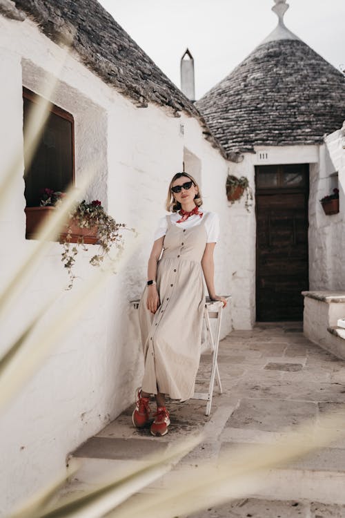 Woman Standing by Entrance to Trulli in Alberobello