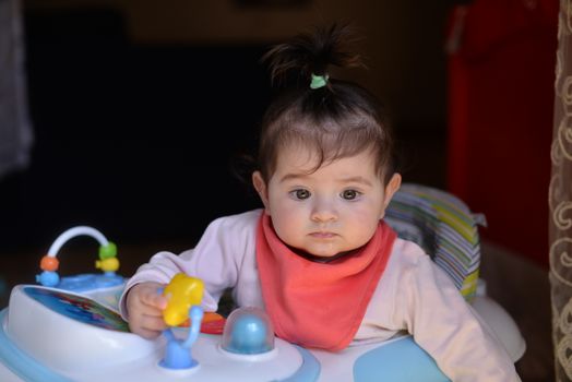 A Little Girl Sitting in a Baby Bouncer
