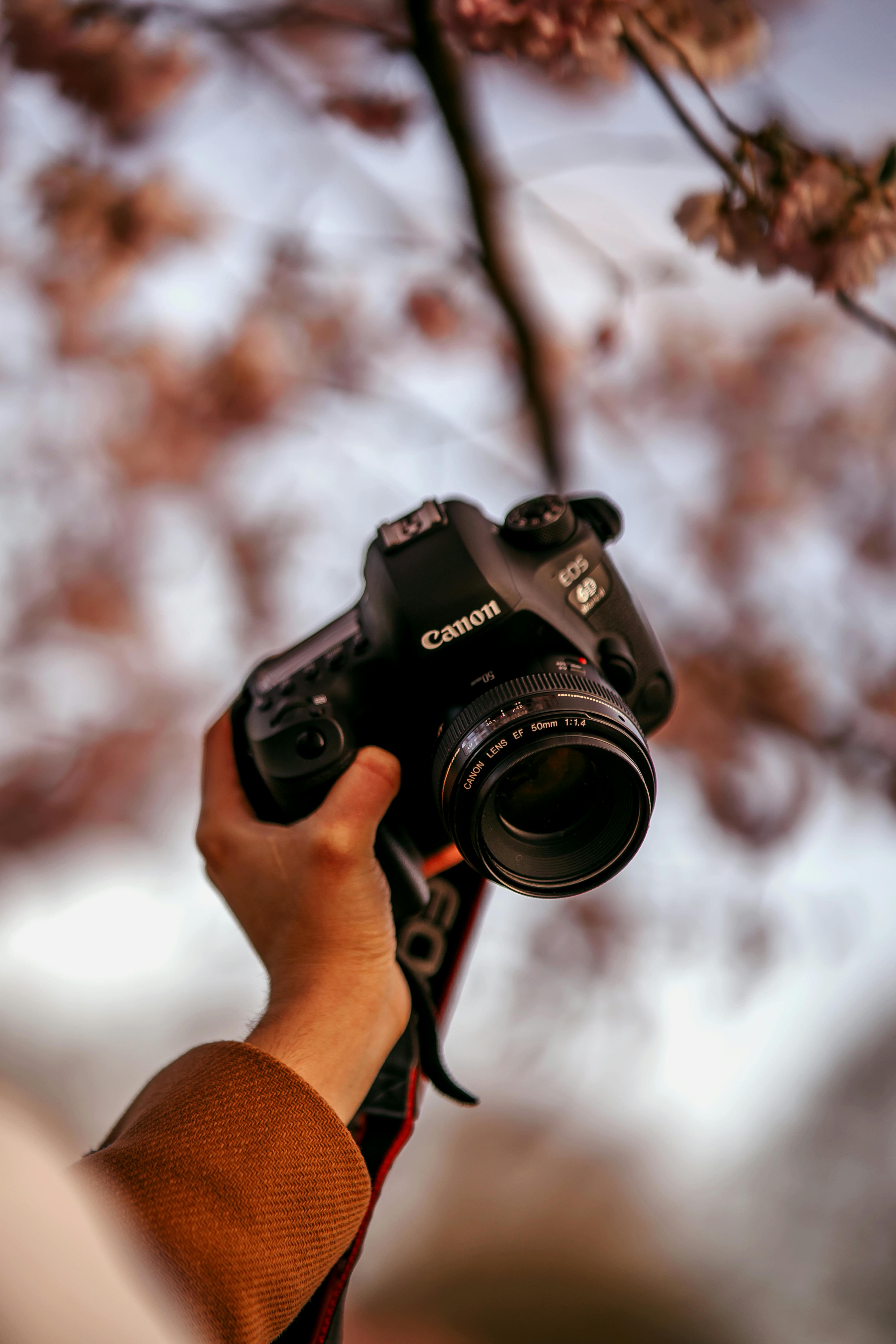 Man Holding Camera While Squating With Smoke on Face Inside Building
