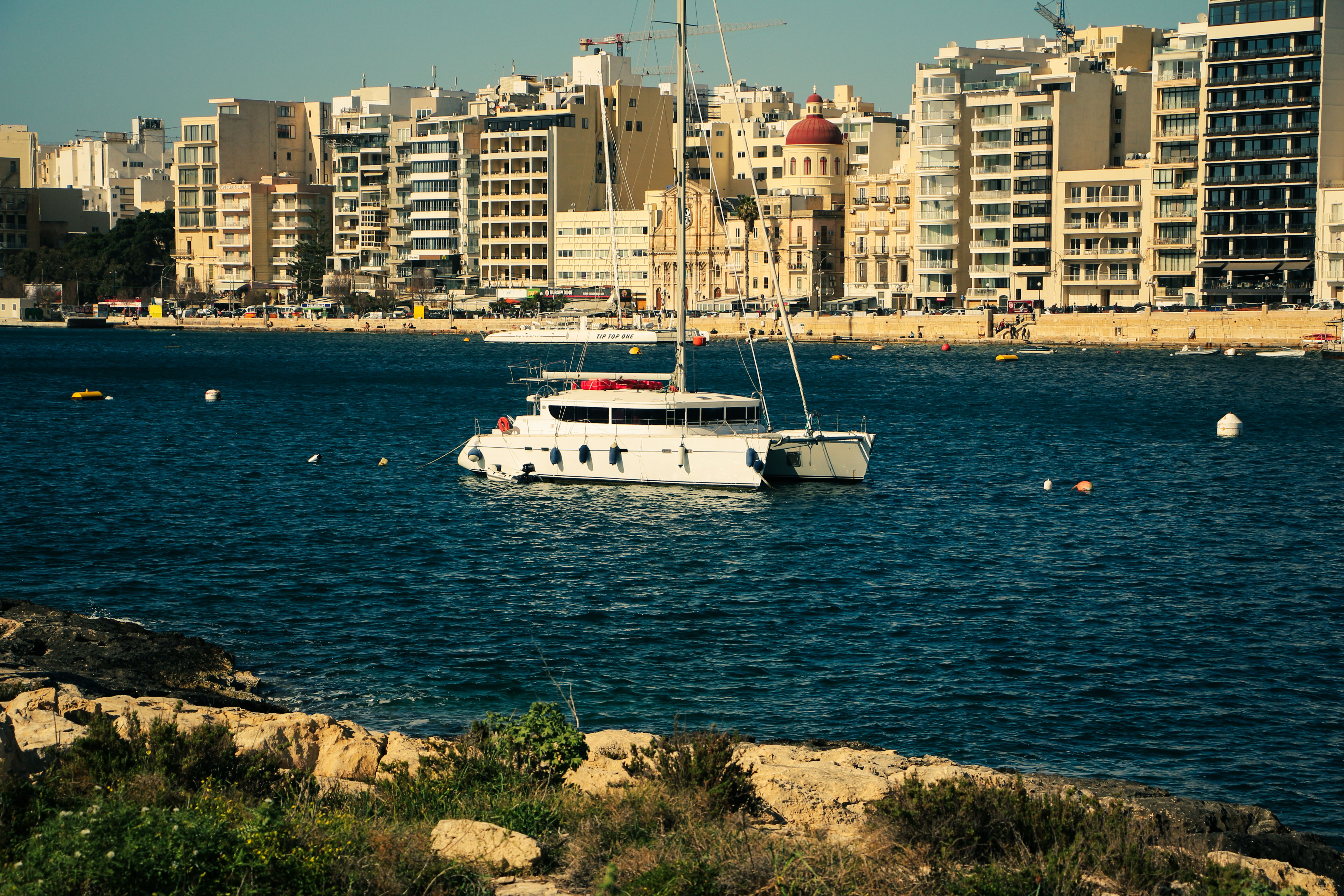 Incredible RYA Practical Sail Cruising Course in Malta for 5 Days (Sleep Onboard Included) Review 2026 - A luxurious yacht anchored on Valletta's beautiful waterfront, showcasing the vibrant cityscape.