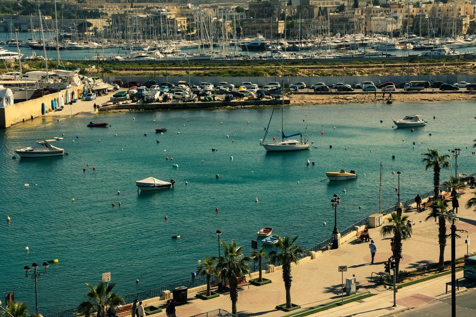 Stunning Private Yacht Charter Tour in Malta, Gozo and Comino - Half-Day Review 2026 - Aerial view of a lively marina in Valletta, Malta with boats and a picturesque town backdrop.