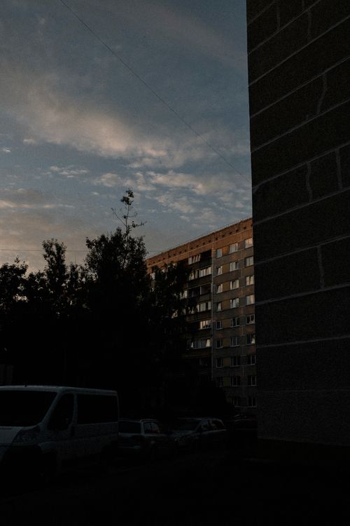 Free Cityscape with silhouette of residential buildings and trees at twilight. Stock Photo