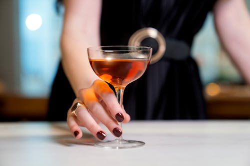 Closeup of a Woman Holding a Glass of a Liquor