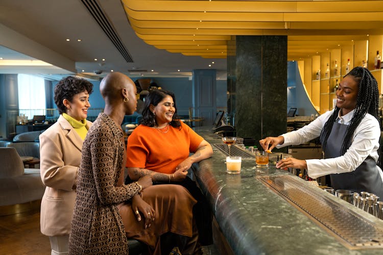 Group Of People Sitting In A Bar