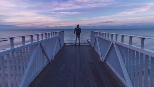 Man Standing At The Pier