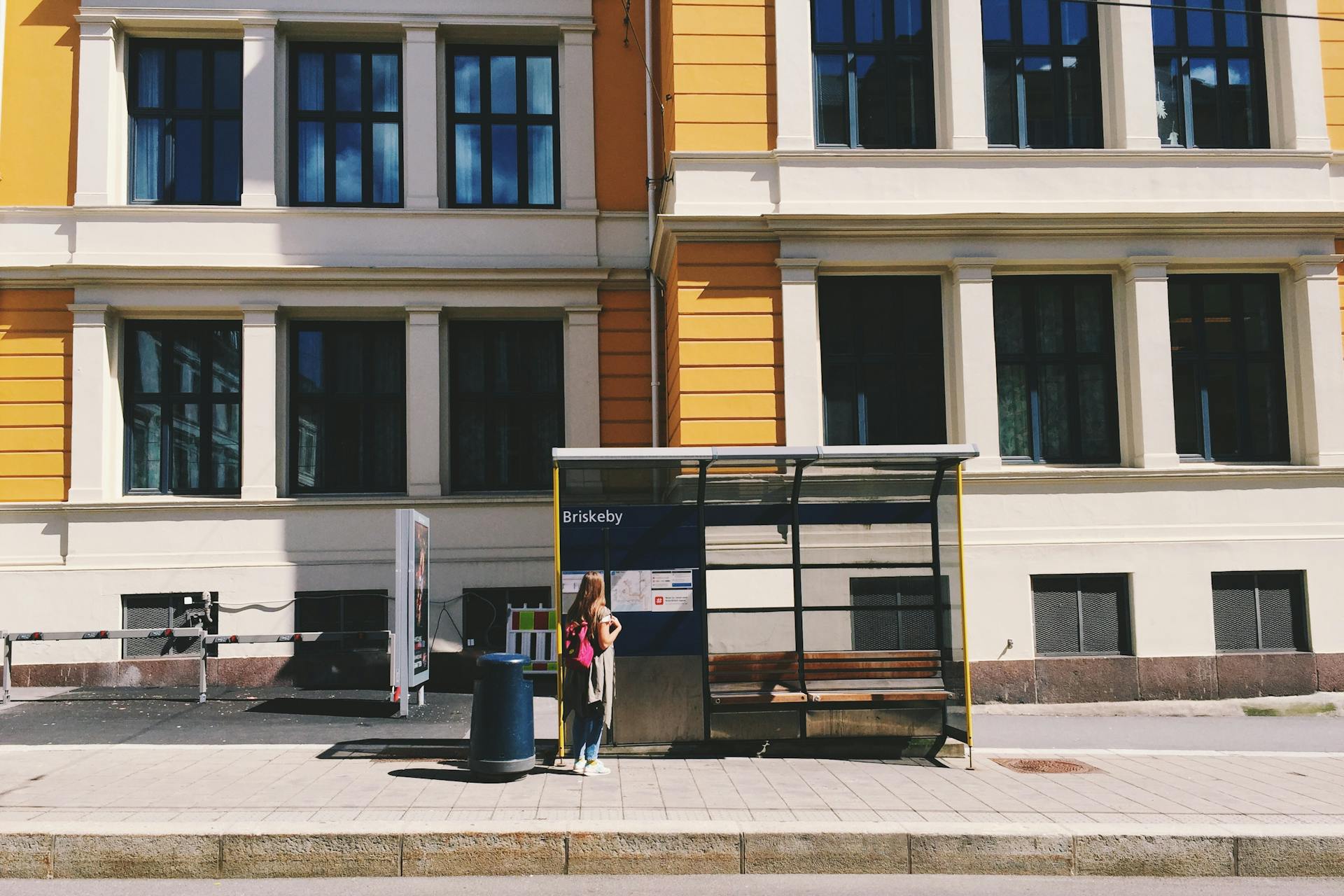 Photo of Woman Standing in Waiting Shed