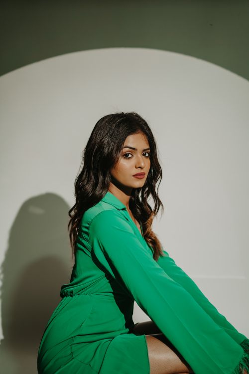 Free Sophisticated fashion portrait of a woman in a green dress, exuding elegance. Stock Photo