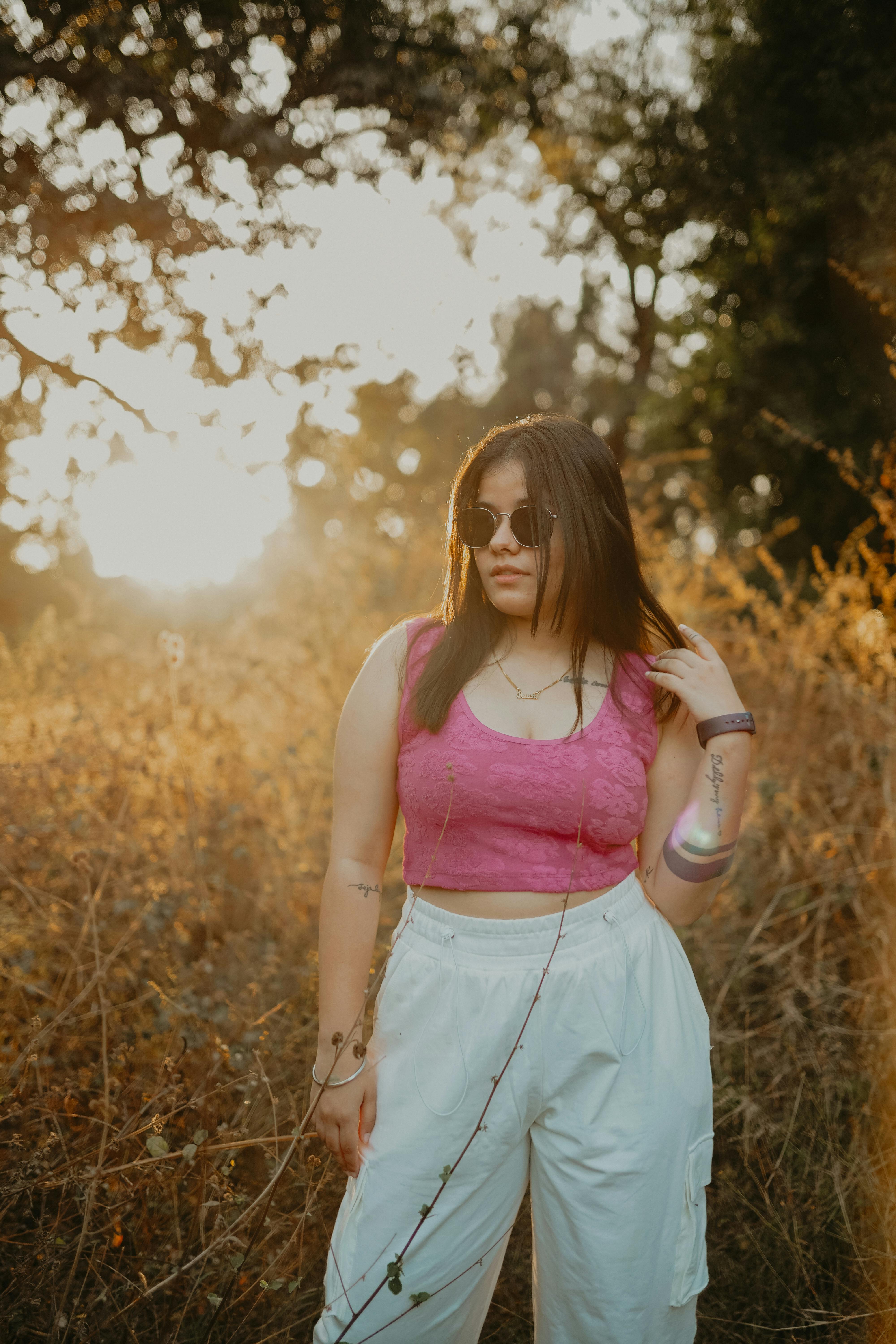 Photo of a Woman Wearing a Red Crop Top and Brown Pants · Free