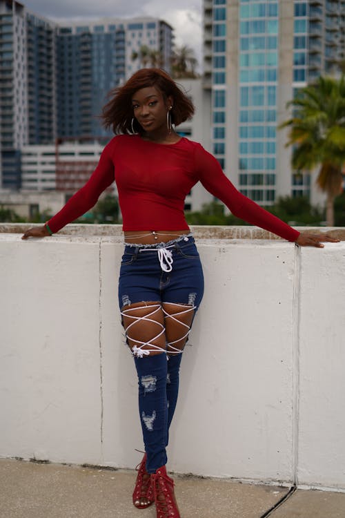 Model in a Red Blouse and Distressed Jeans