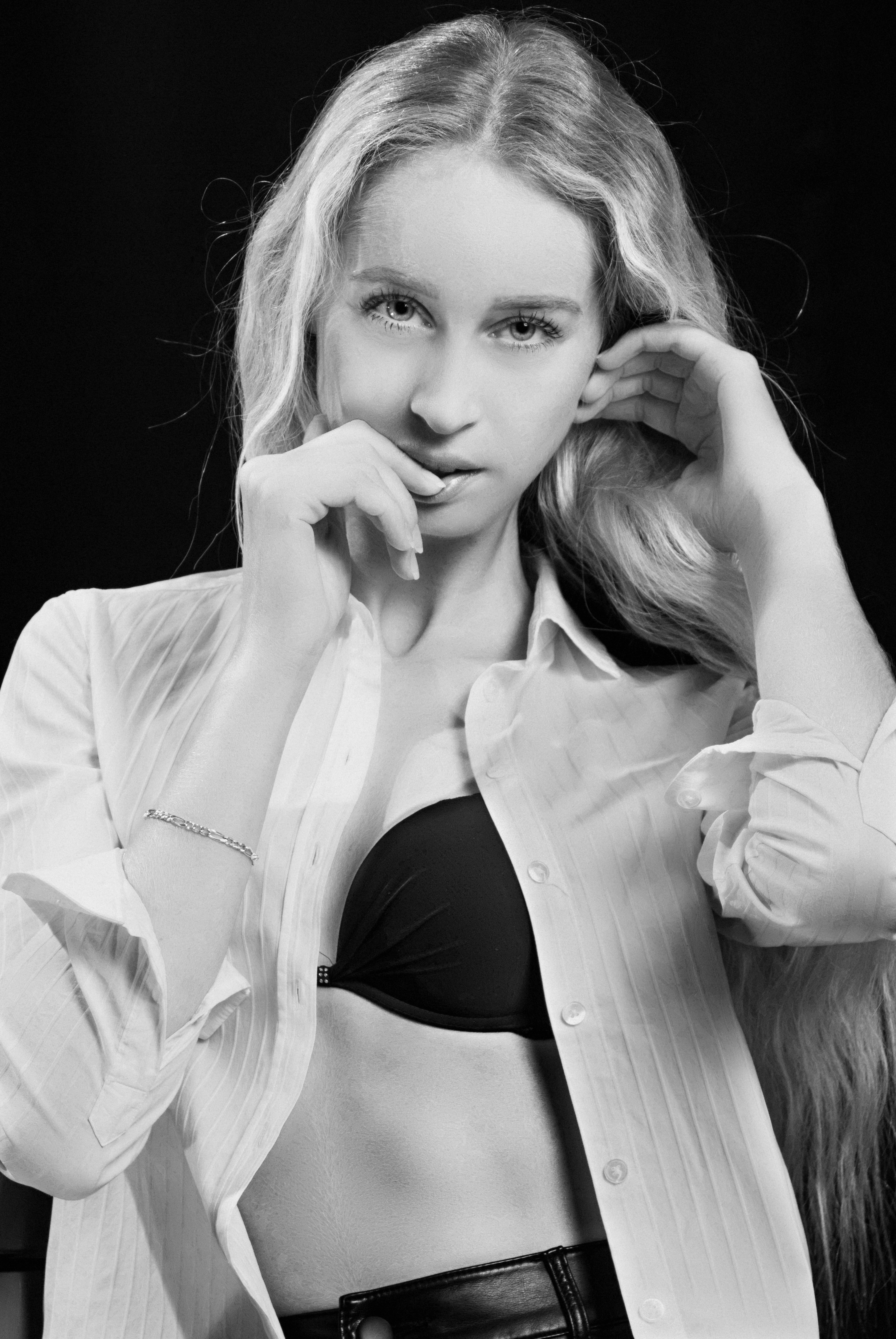 Black and white portrait of a woman in a stylish pose, exuding elegance and confidence.