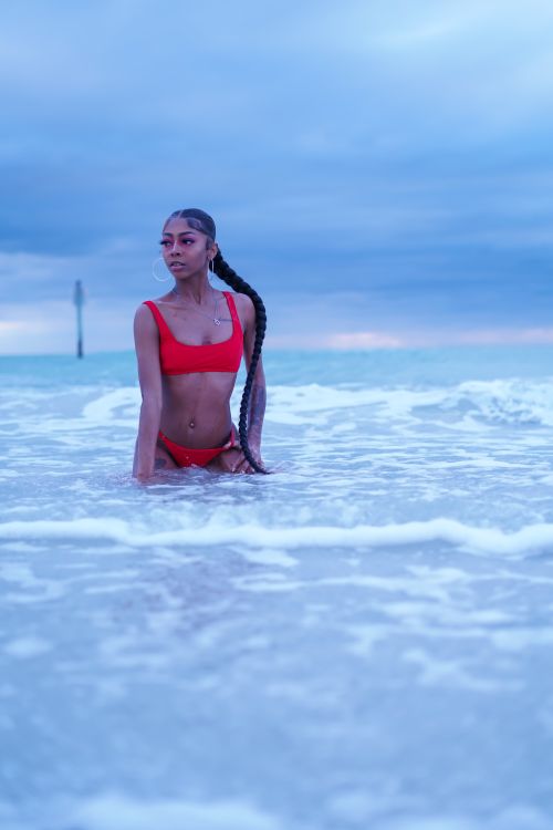 Free A woman enjoys the ocean in Clearwater, Florida during summer, highlighting leisure and relaxation. Stock Photo