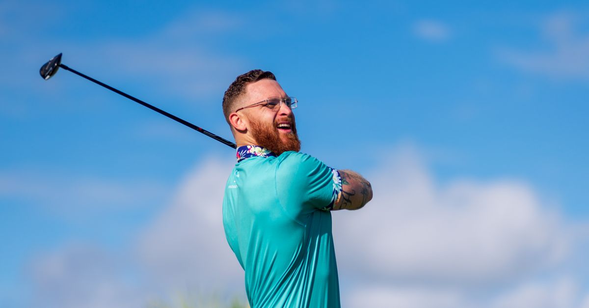Photo by Steve Momot A male golfer enjoying a precise golf swing on a clear sunny day outdoors.
