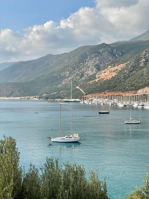 Free Tranquil seaside view of sailboats in Kaş, Antalya, with majestic hills. Stock Photo