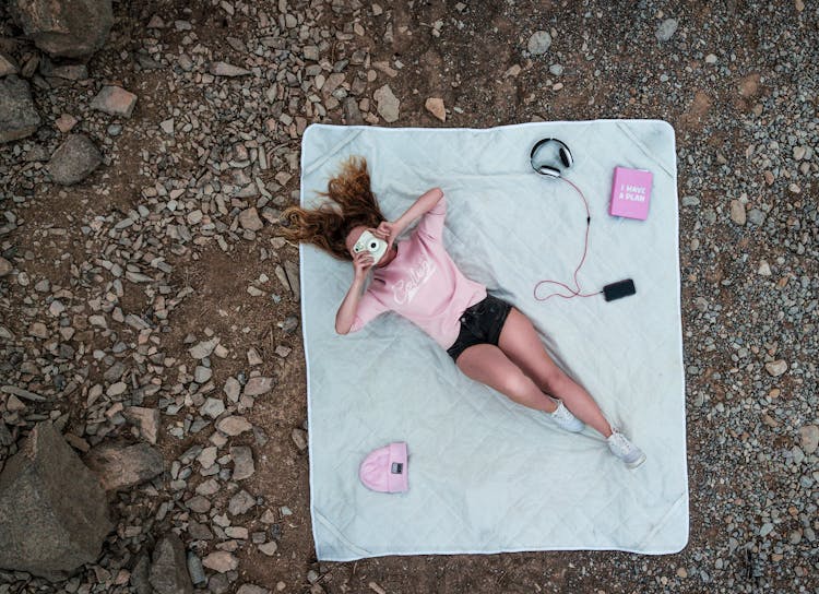 Top View Photo Of Woman Lying On Mattress