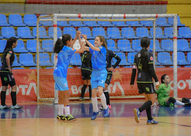 Girls Playing Soccer At The Gymnasium