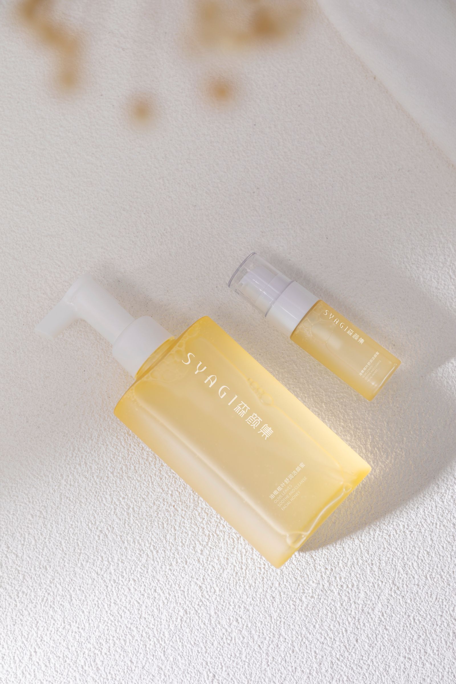 Minimalist skincare bottles displayed on a white surface without people