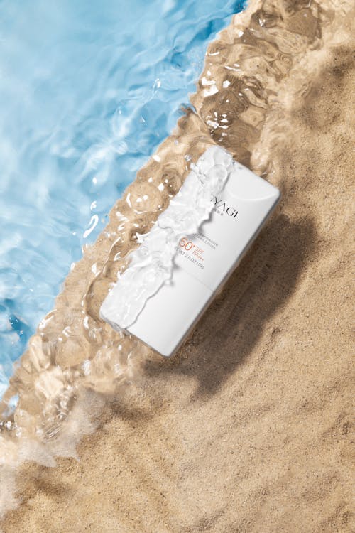 Cosmetics Tube in Water and on Sand