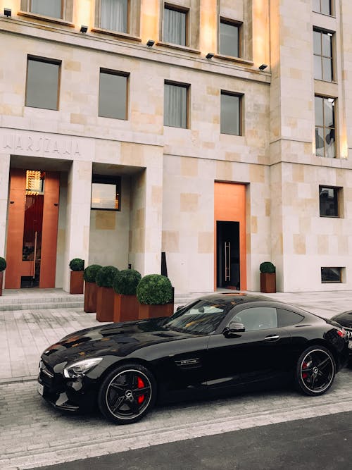 Free Black Coupe Parked In Front Of Building Stock Photo
