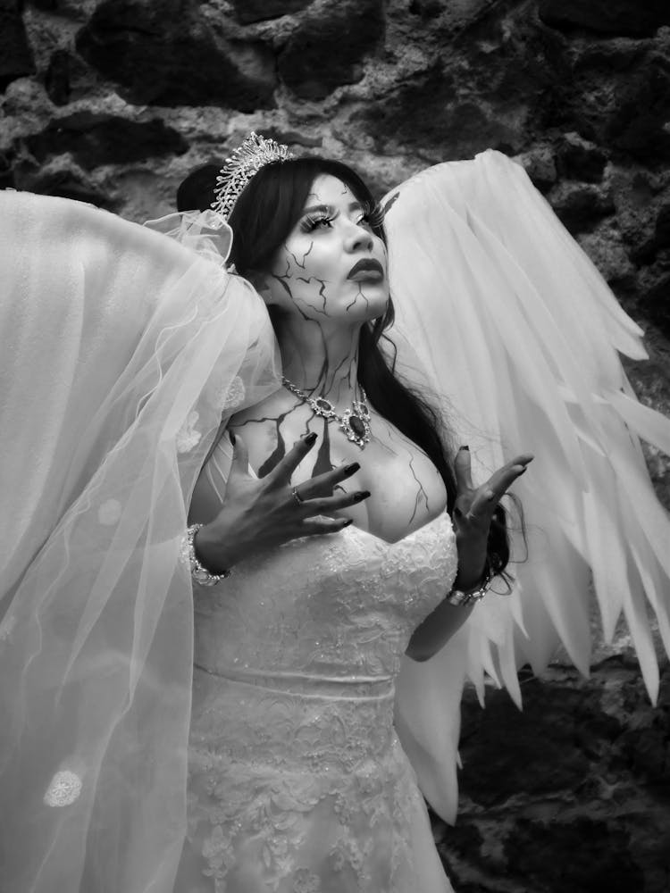 Woman In Wedding Dress With Angel Wings For Halloween