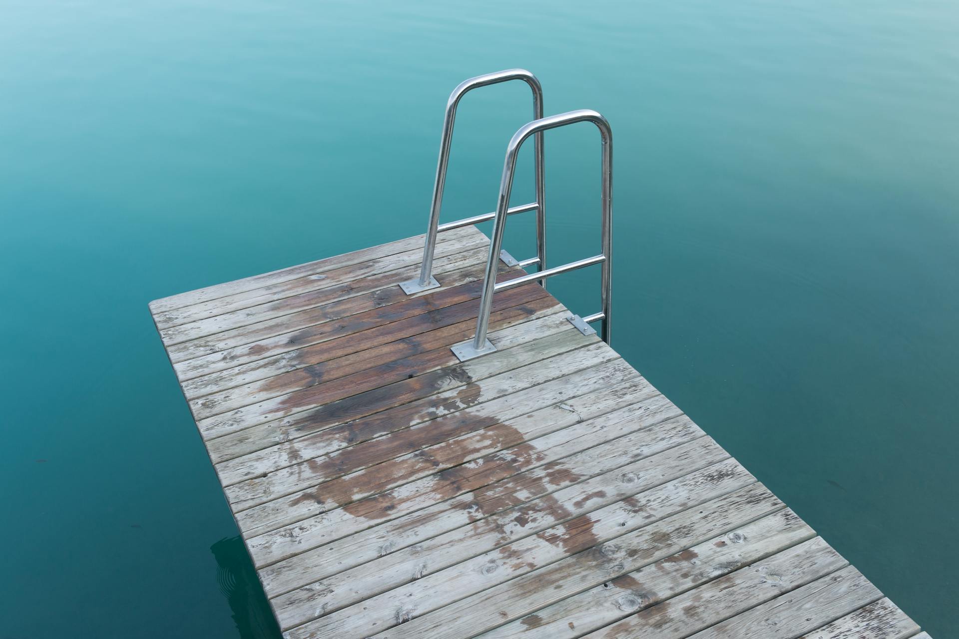 Empty Brown Wooden Dock With Ladder on Body of Water