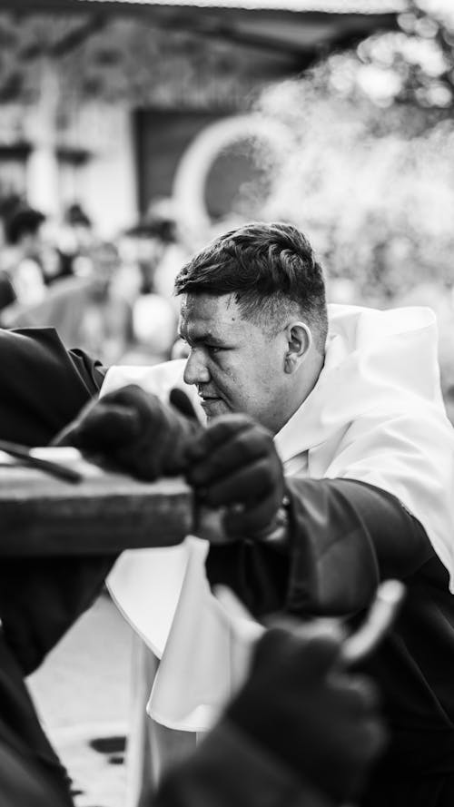 Black and White Photo of a Man Wearing a White Gown 