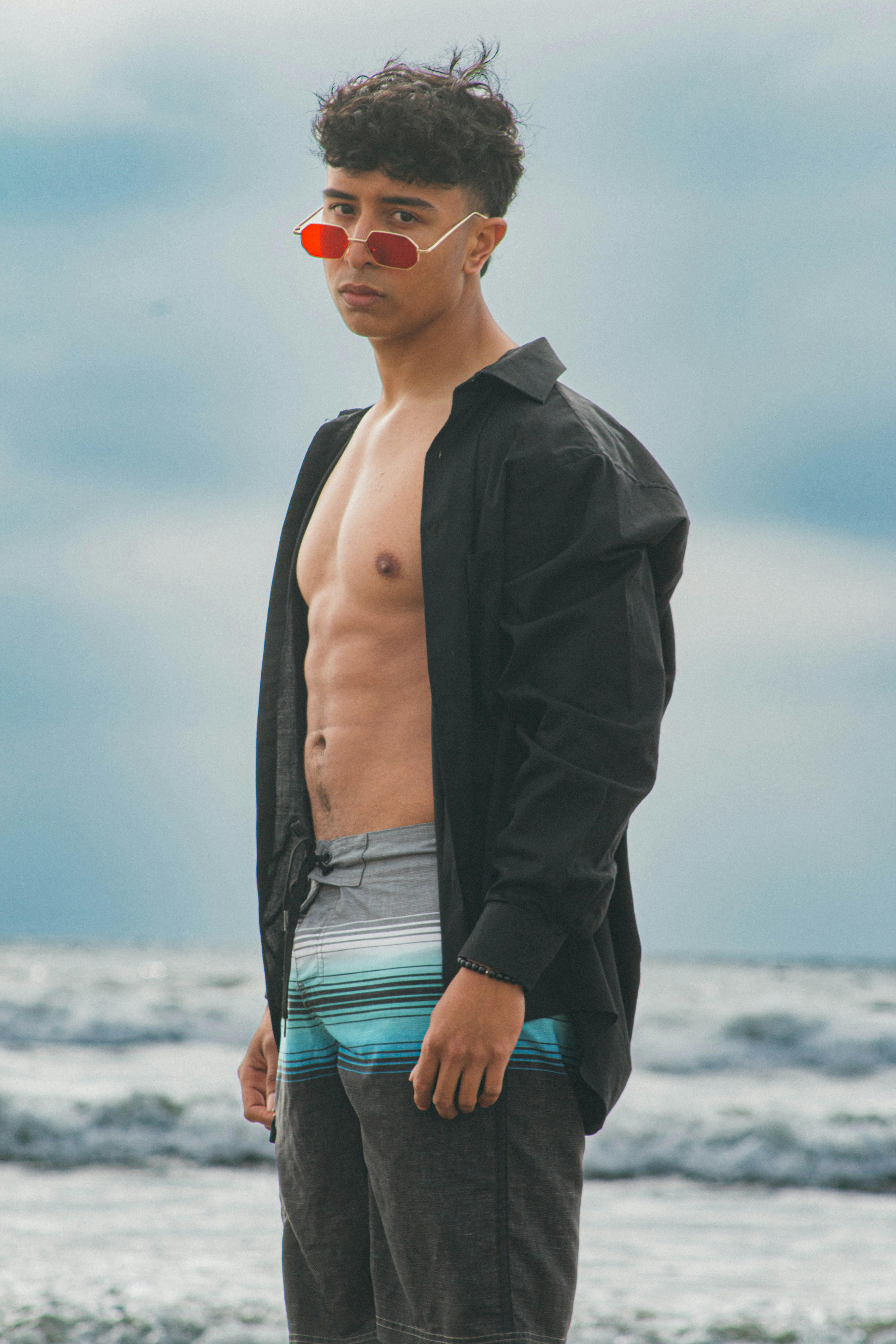 Young Man Posing on the Beach Wearing an Unbuttoned Denim Jacket · Free  Stock Photo