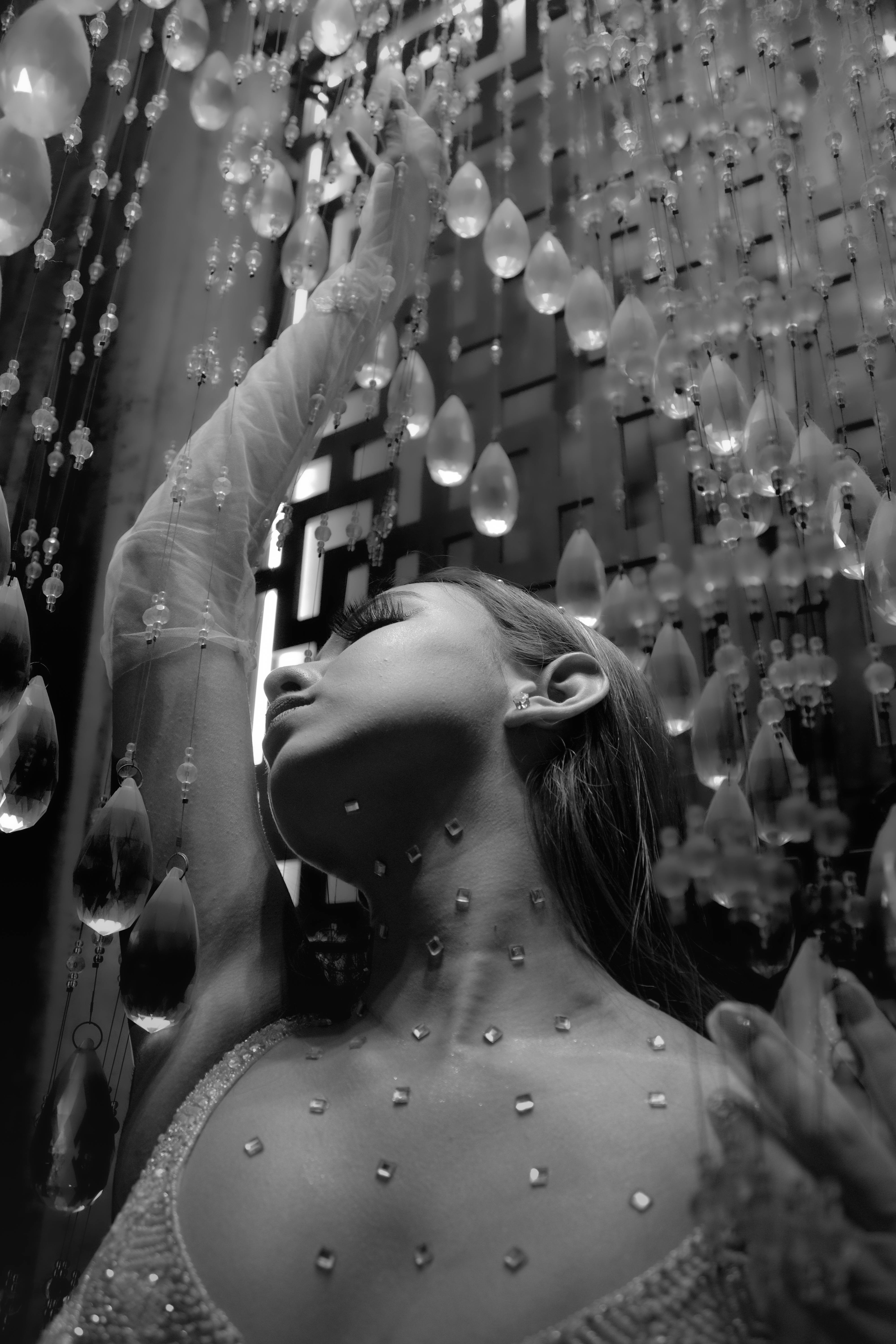 Free Artistic black and white portrait of a woman surrounded by crystals, exuding elegance. Stock Photo