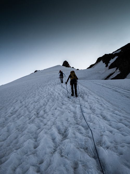 People Hiking in Mountains in Winter