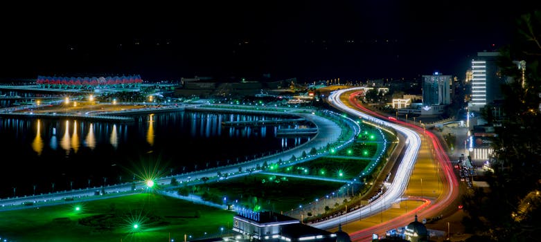 Night view of Baku's coast, showcasing vibrant city lights and a glowing urban landscape.